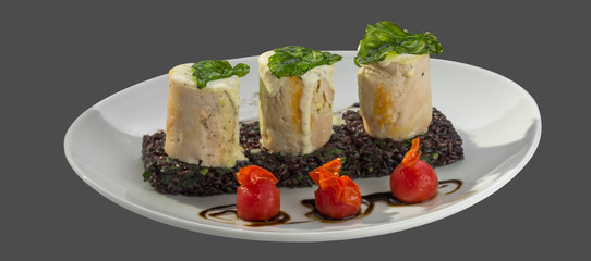 Roll meat with sauce on a bed of brown rice