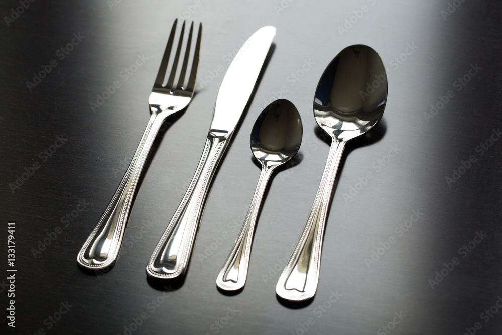 Wall mural cutlery on a black background. fork, spoon, knife.