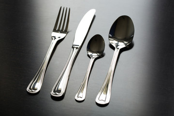 Cutlery on a black background. Fork, spoon, knife.