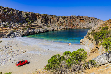 Happy traveler family sitting on the beach under umbrella. Amazing bay with turquoise water 4x4...