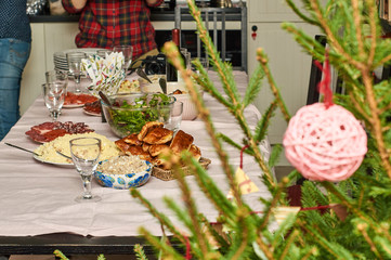 Family setting the festive table to celebrate the New Year holiday.