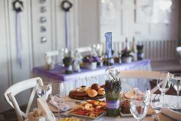 Dining table setting at Provence style, with candles, lavender,