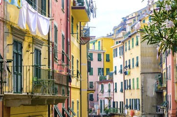 Riomaggiore village, La Spezia, Liguria, northern Italy. View of the colourful houses on steep hills and laundry on balconies. Part of the Cinque Terre National Park and a UNESCO World Heritage Site.