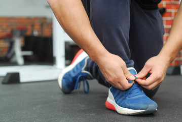 Footballer tying shoelaces before the game