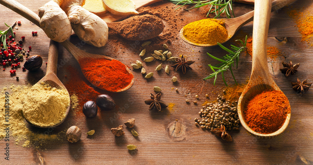 Sticker Various spices on a wooden board.