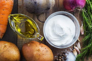 Ingredients for cooking, beets, potatoes, carrots, onions, garlic, dill, butter and sour cream. Ingredients for borsch or beetroot. Organic vegetables close-up view from above. Top view, flat lay.