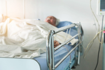 Close up bed of  hospital ward room during elderly patient sleep with digital device for measuring blood pressure monitor - 133184266