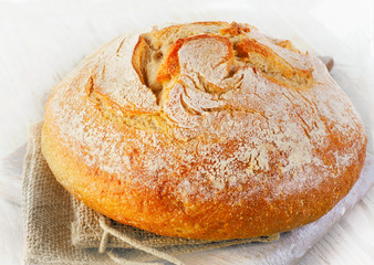 Traditional homemade bread on wooden table.