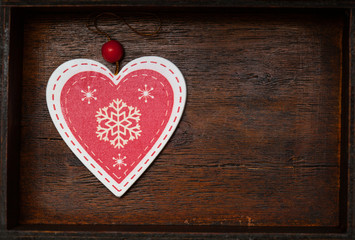 red heart with snowflakes on a beautiful wooden background, top view. Blank space for text and design