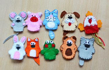 Fototapeta na wymiar 10 felt finger puppets: mouse, pig, cat, dog, cock, fox, rabbit, frog, bear, wolf
