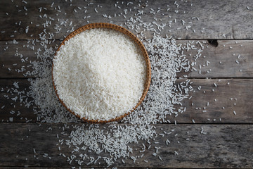 Mix size jasmine rice on the wood background