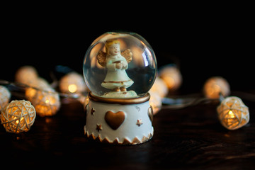 figure on the background bokeh. souvenir. Angel in a glass bowl
