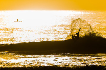 Surfer surfing in the sunset