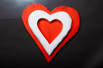 Holidays gift and heart on a black background. Valentines day