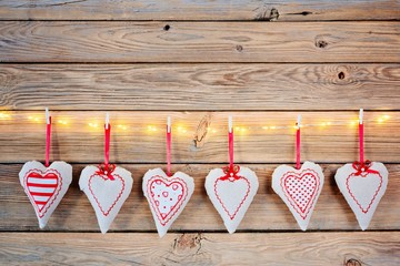 Textile hearts on old wooden rustic background.