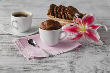 Sweets with coffee and lily flower on table