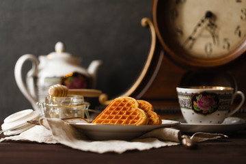 Viennese wafers on dark table with tea cup