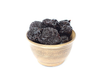 dried plums in a bowl on a white background