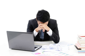 young asia businessman working at office with laptop and having a problems at the office on white background