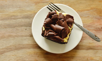 chocolate butter cake topping slicing chocolate and fork on dish