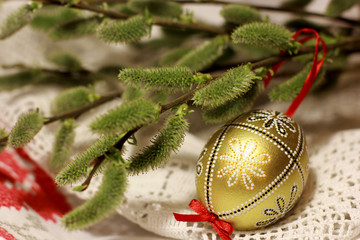 Palm Sunday card. Spring of flowering tree branches with handmade decorated Easter egg.