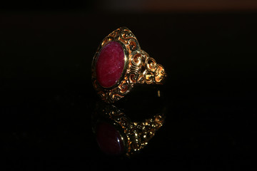 Jewellery diamond ring and gemstone on a black background