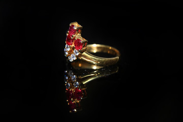 Jewellery diamond ring and gemstone on a black background