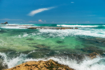 Sunny beach near Koggala - Sri Lanka. Waves of clear water and warm sand 