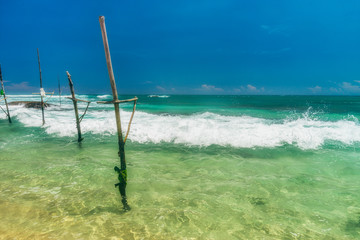 Sunny beach near Koggala - Sri Lanka. Waves of clear water and warm sand 