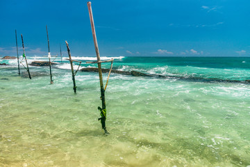 Sunny beach near Koggala - Sri Lanka. Waves of clear water and warm sand 