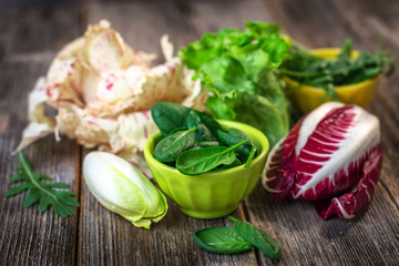 Fresh colorful  lettuce on wooden background