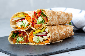 Healthy vegan salad tortilla wraps with tofu and vegetables. Love for a healthy raw food concept.
