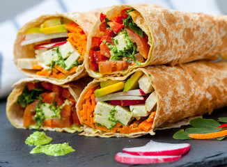 Healthy vegan salad tortilla wraps with tofu and vegetables. Love for a healthy raw food concept.