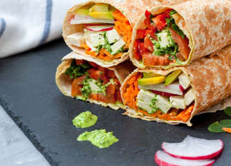 Healthy vegan salad tortilla wraps with tofu and vegetables. Love for a healthy raw food concept.