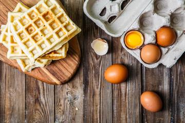 Several Belgian waffles with eggs