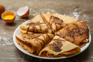 Hot pancakes with chocolate close-up