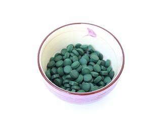 spirulina in a bowl on a white background