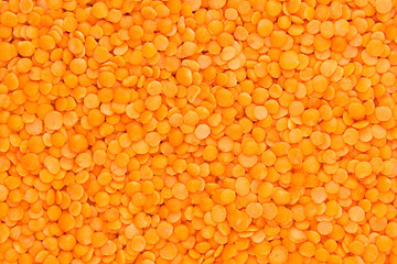 Red purified lentil closeup top view background. Healthy protein food.