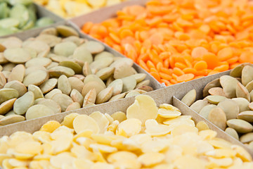 Lentils background, assortment  - red, yellow, green  in square cells macro. Healthy protein food.