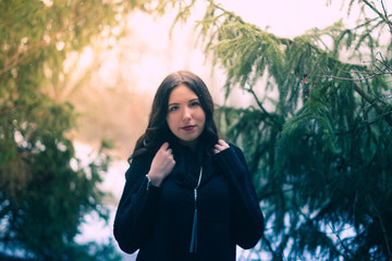 Young girl in the forest pine winter