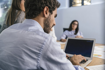 Young team of coworkers doing a meeting in a modern studio