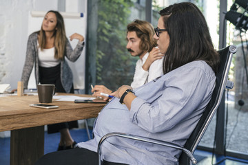 Young team of coworkers doing a meeting in a modern studio