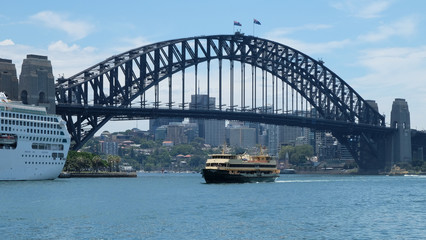 Sydney Ferry on harbour passing in front of bridge