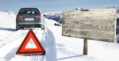 winter road and car with road sign 