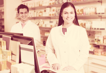 Portrait of pharmacist and assistant working