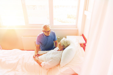 senior couple meeting at hospital ward