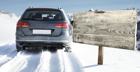winter road and car with road sign 