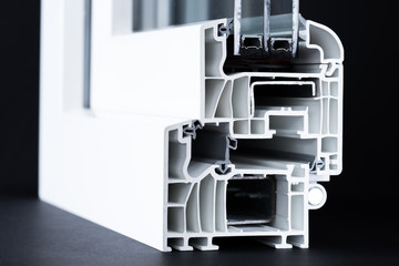 cut of pvc window profile closeup, triple glazing, black background