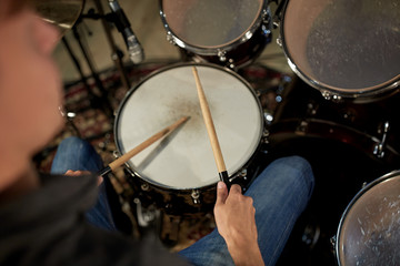 Fototapeta na wymiar man playing drums at concert or music studio