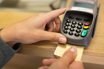 close up of hand inserting bank card to terminal